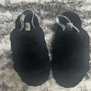Girls black Ugg fur slippers.
